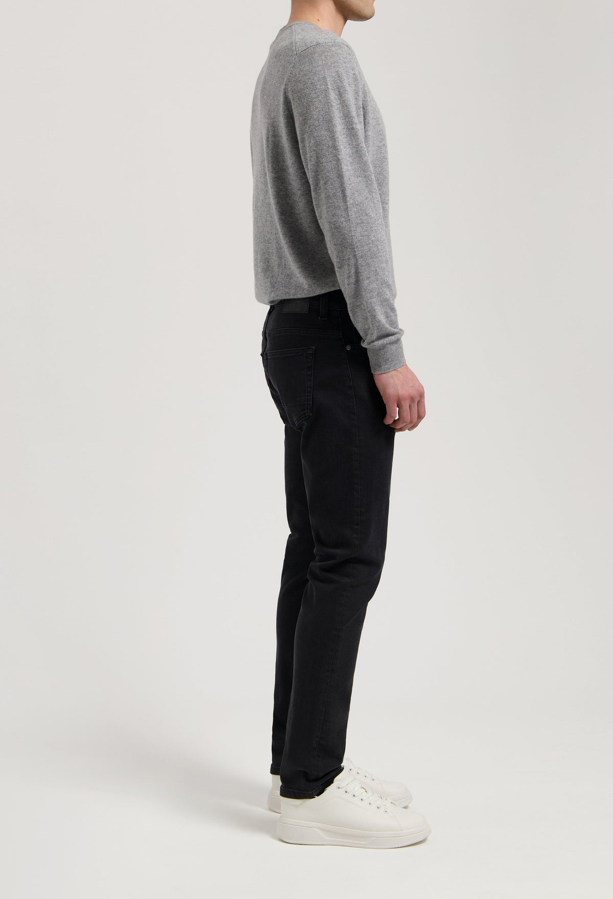Sustainable MUD Jeans in deep blue denim, crafted ethically, styled with matching denim jacket, showcasing eco-friendly fashion.