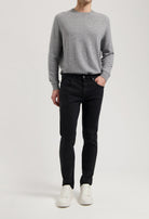 Sustainable MUD Jeans ensemble featuring dark denim shirt and blue jeans, highlighting ethical fashion in classic style.
