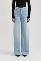 Light blue, high-waisted wide-leg jeans paired with a long-sleeve black top, showcasing a modern casual style.