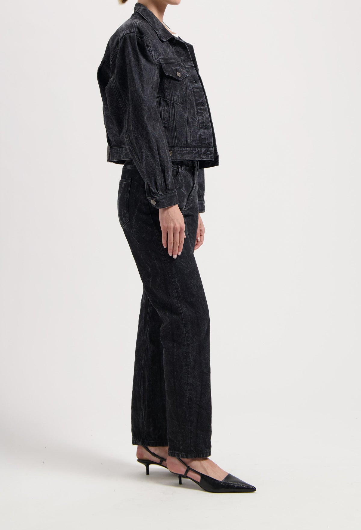 Dark wash denim jacket and wide-leg jeans ensemble paired with black pointed-toe heels, showcasing a chic casual outfit.