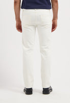 Sustainable MUD Jeans in deep blue denim, relaxed fit, worn with a black t-shirt and white sneakers for an ethical style.