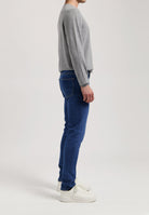 Sustainable MUD Jeans blue denim shorts paired with a white T-shirt, emphasizing eco-friendly fashion and style.
