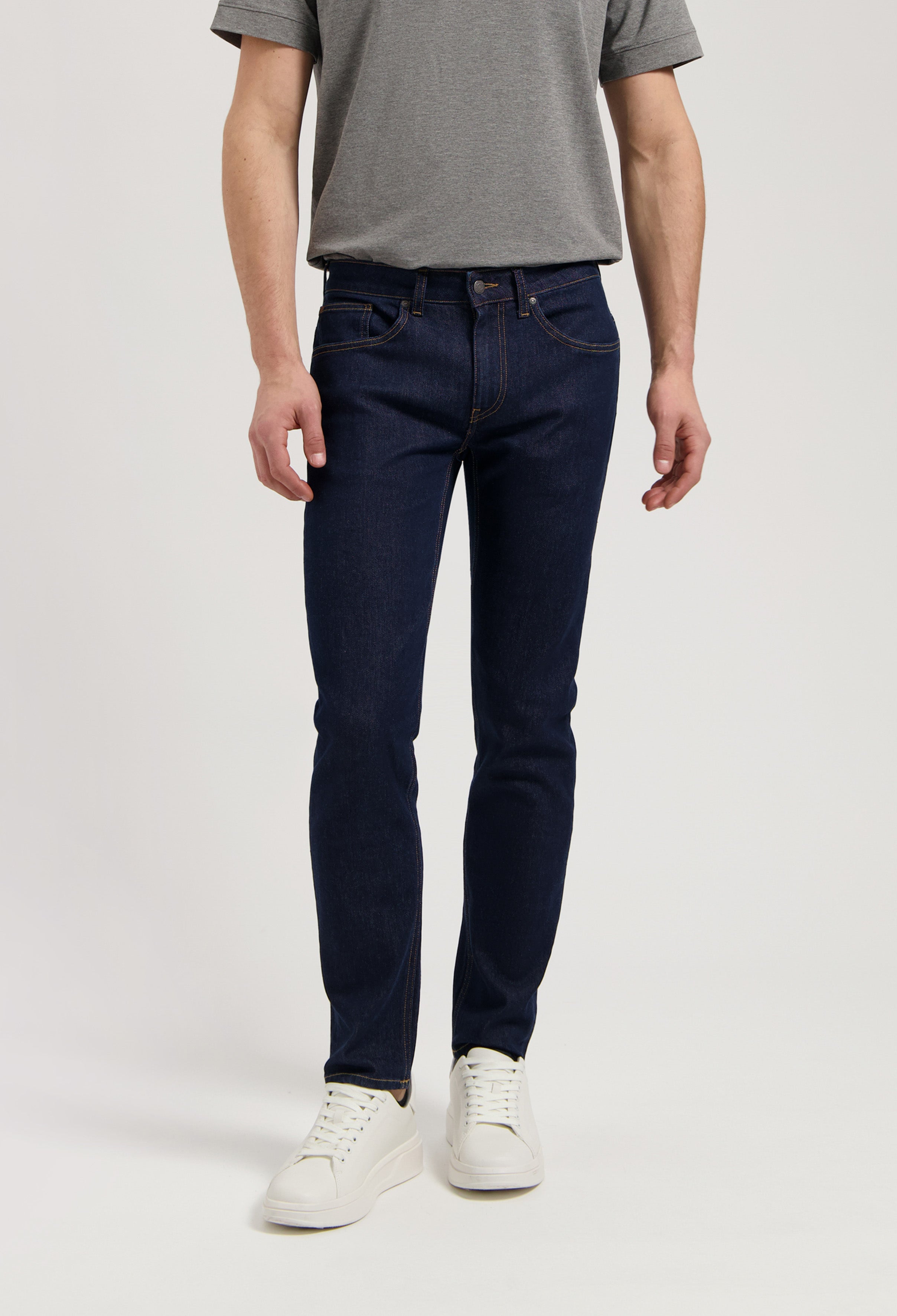 Sustainable MUD Jeans in black denim paired with a cozy gray sweater, showcasing ethical and eco-friendly fashion.