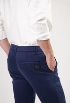 Sustainable MUD Jeans in dark gray denim, crafted ethically, showcasing a slim fit style paired with black sneakers.