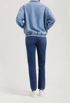 Casual blue denim jacket paired with matching blue jeans, showcasing a relaxed fit and elastic waistband design.