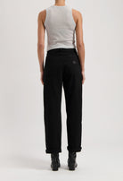 Back view of model wearing black high-waisted jeans paired with a gray sleeveless top, showcasing modern casual fashion style.
