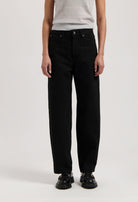 Wide-leg black pants paired with a sleeveless gray top, showcasing a casual and minimalist fashion style.