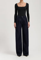 Model wearing Carry Mid Straight jeans in black vintage, made from sustainable organic and recycled cotton, offering a straight fit.