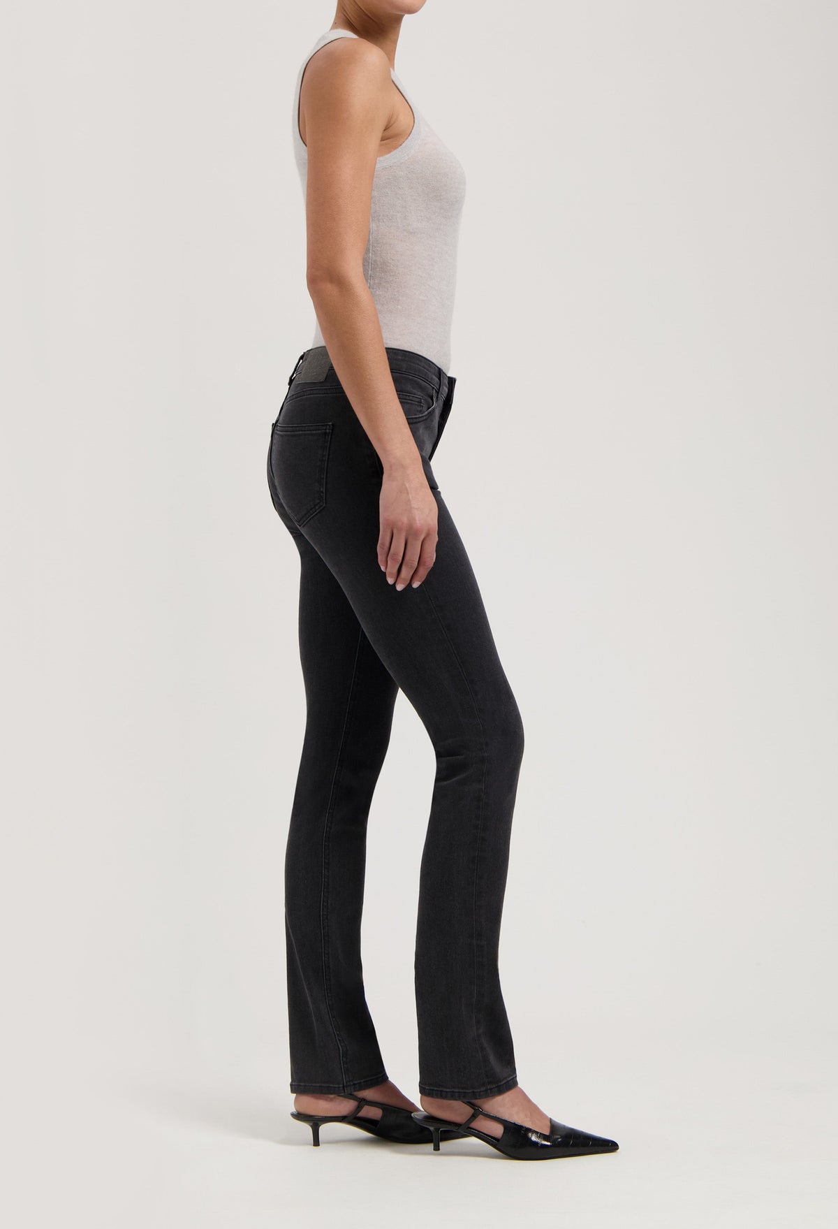 Slim-fit black denim jeans paired with a light gray tank top, highlighting the casual and elegant style for everyday wear.