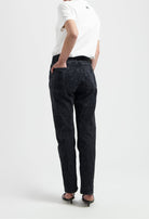 High-waisted black denim jeans with a casual fit, styled with a simple white T-shirt and black strappy sandals.